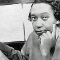Julia Perry - photographer unknown African American composer Julia Perry has very short hair in the fashion of the 1940s. She is sitting at a piano