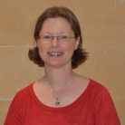 Louise Stewart, director, Multitude of Voyces Multitude of Voyces founder Louise Stewart, a middle-aged woman with short brown hair wearing a bright red top