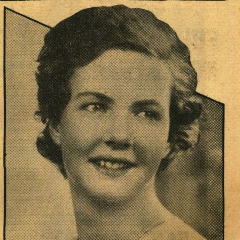 composer Greta Tomlins in a black-and-white newspaper photo in 1934. She looks away from the camera and smiles shyly. 