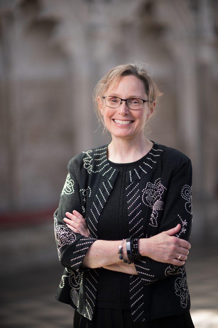 Sarah MacDonald ©Nick Rutter Canadian composer Sarah MacDonald with short blonde hair tied back, thin rimmed glasses wearing a black and white embroidered jacket