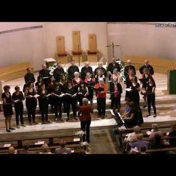 Anglina Figus - photographer unknown Italian composer Angelina Figus wearing black trousers and a red jacket conducting a choir of girls and women in a church