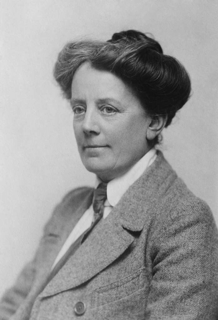 Ethel Smyth ©London Metropolitan University composer and suffragette Dame Ethel Smyth wears a full length skirt and long jacket with bow tie at a WSPU meeting in 1912