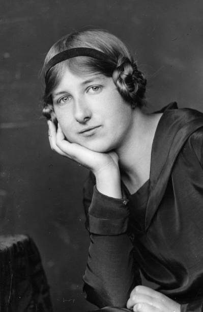 Imogen Holst - photo: George Charles Beresford composer Imogen Holst circa 1930 with narrow headband and hair plaited and curled around her ears, wearing a loose-fitting dress