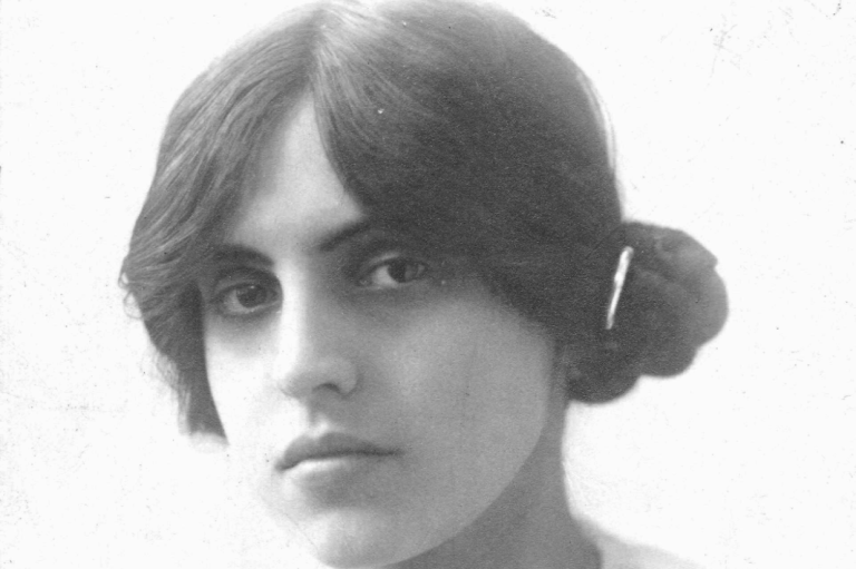 Black-and-white portrait of composer Morfydd Owen circa 1911 with dark hair pinned in a loose bun. She is looking directly at the camera.