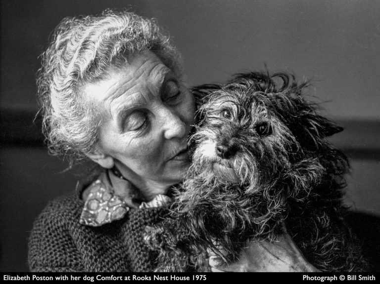Elizabeth Poston ©Bill Smith, licenced to MoV Elizabeth Poston holds her small dog, Comfort, at Rooks Nest House in 1975. She is aged 70